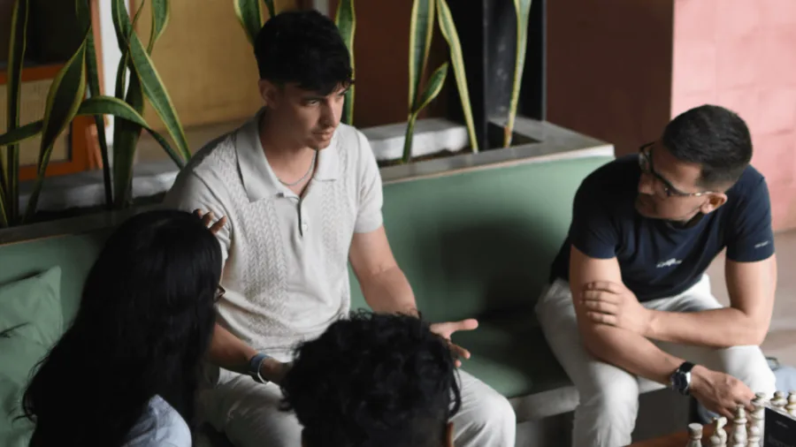 A small group sitting together on sofas, talking.